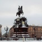 Snow-covered Monument to Nicholas I in Saint Petersburg's urban landscape.