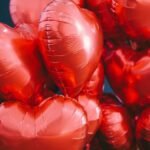 Vibrant red heart-shaped balloons, perfect for Valentine's Day or romantic celebrations.