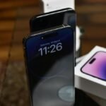 Stylish setup of iPhone 14 Pro showcasing dynamic island feature with accessories.