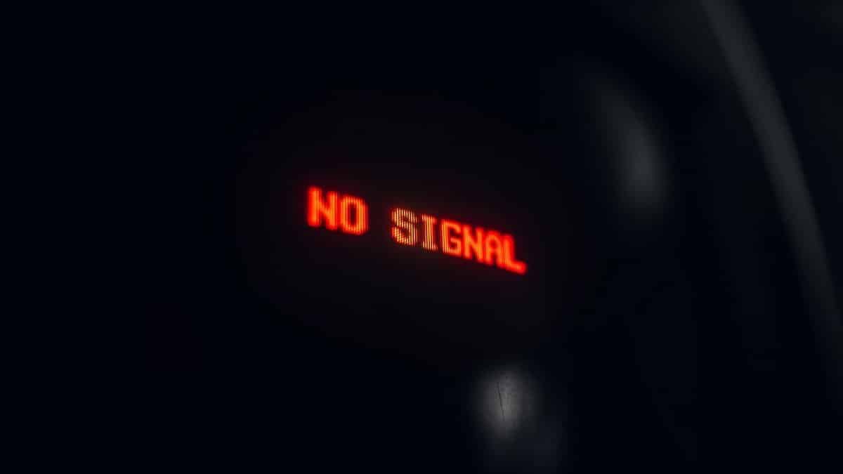 A red LED display indicating 'No Signal' in a dark setting, conveying a tech warning.
