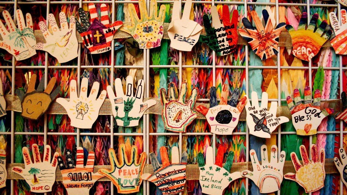 A vibrant collection of handmade handprints as a tribute with artistic designs, symbols, and colors.