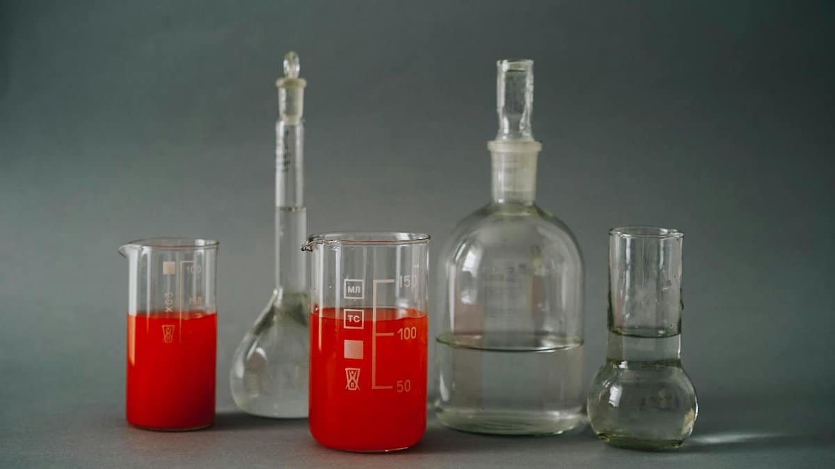 Close-up of laboratory glassware with colorful red liquids used in a chemistry lab.