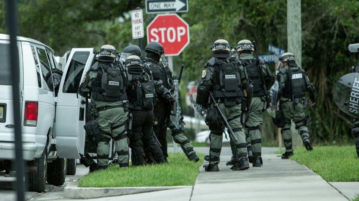 Police tactical unit in action during operation on a street in Brooksville, FL.