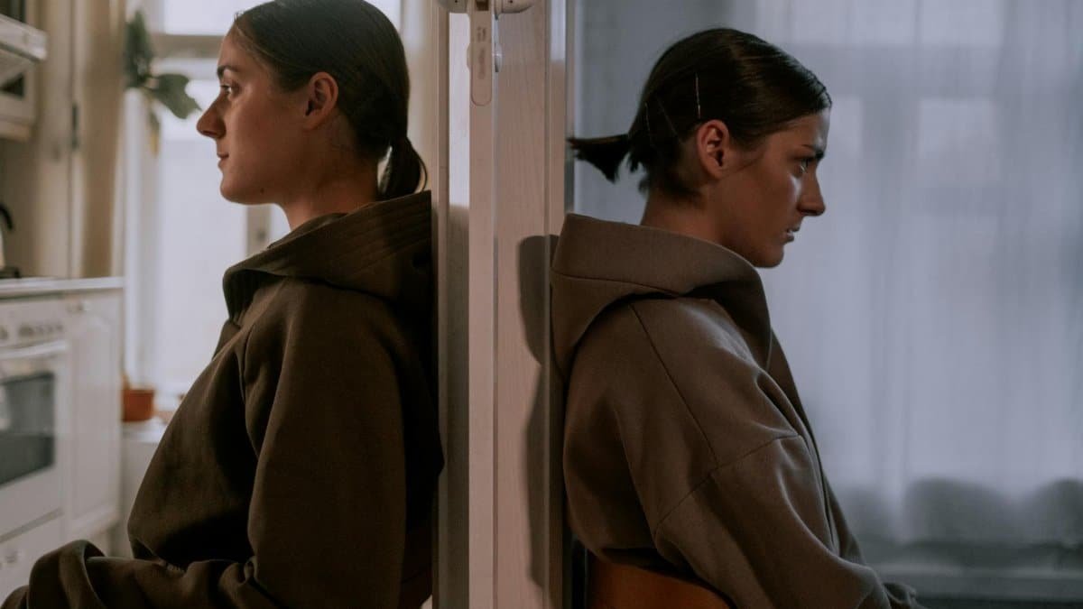 A conceptual portrait of a woman facing inner conflict, depicting mental health themes.