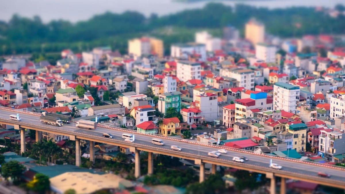 A vibrant aerial view of a bustling urban area with colorful buildings and an elevated highway.