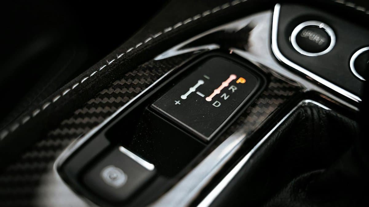 Detailed close-up of a modern car's gear shift indicator showcasing technology and design.