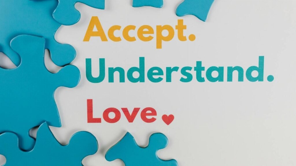 Colorful puzzle pieces with words 'Accept. Understand. Love.' symbolize autism awareness.