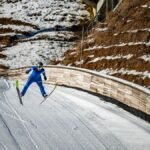 A thrilling ski jumper in vibrant blue suit captures the essence of winter sports at Planica.