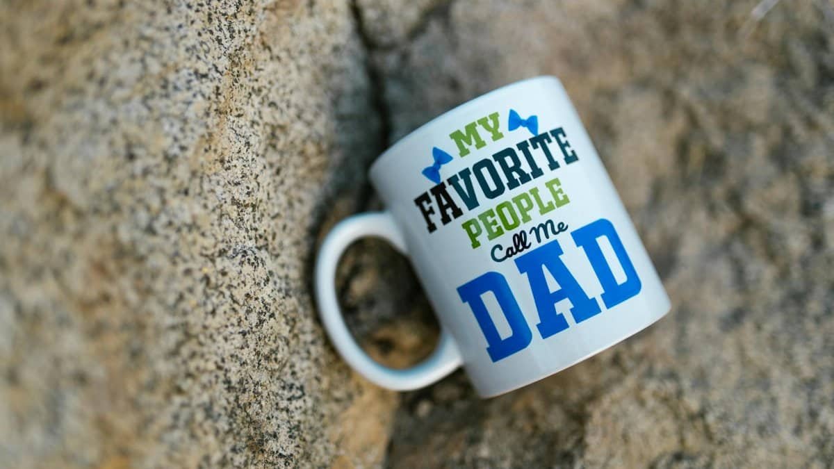 Ceramic mug with 'My Favorite People Call Me Dad' design on a stone background.