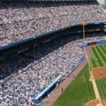 Aerial view of a crowded baseball stadium during a live game.