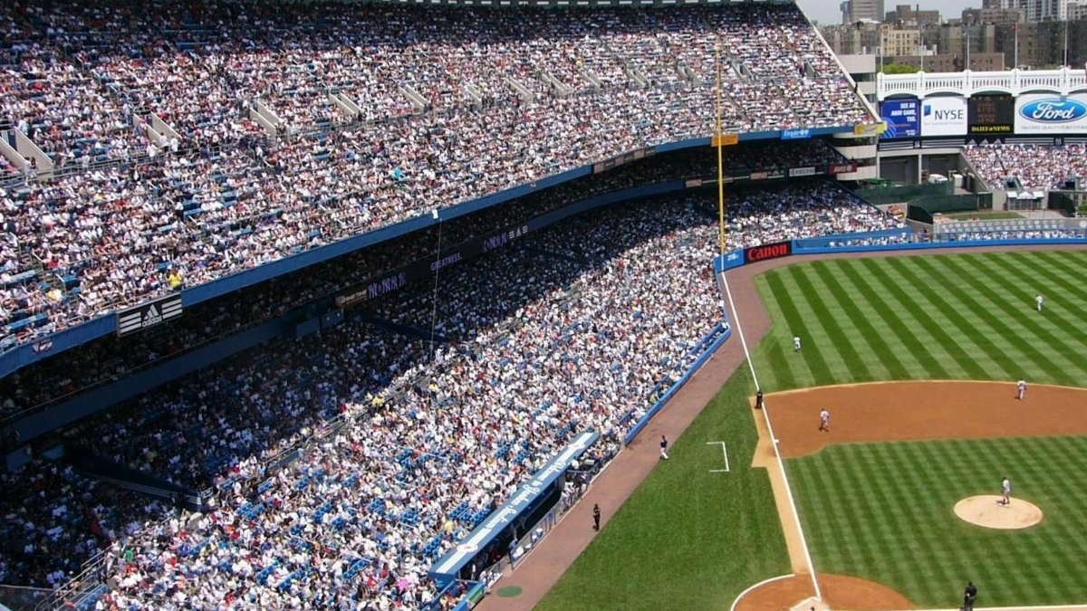 Aerial view of a crowded baseball stadium during a live game.