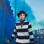 Trendy Gen Z individual with a smoke bomb, showcasing urban street style.