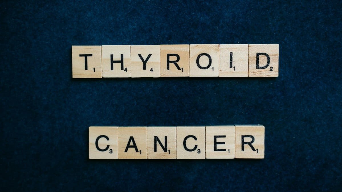 Scrabble tiles spelling 'Thyroid Cancer' on a dark blue background representing awareness.