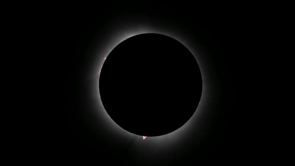 Capture of an annular solar eclipse with glowing corona, showcasing celestial beauty in a dark sky.