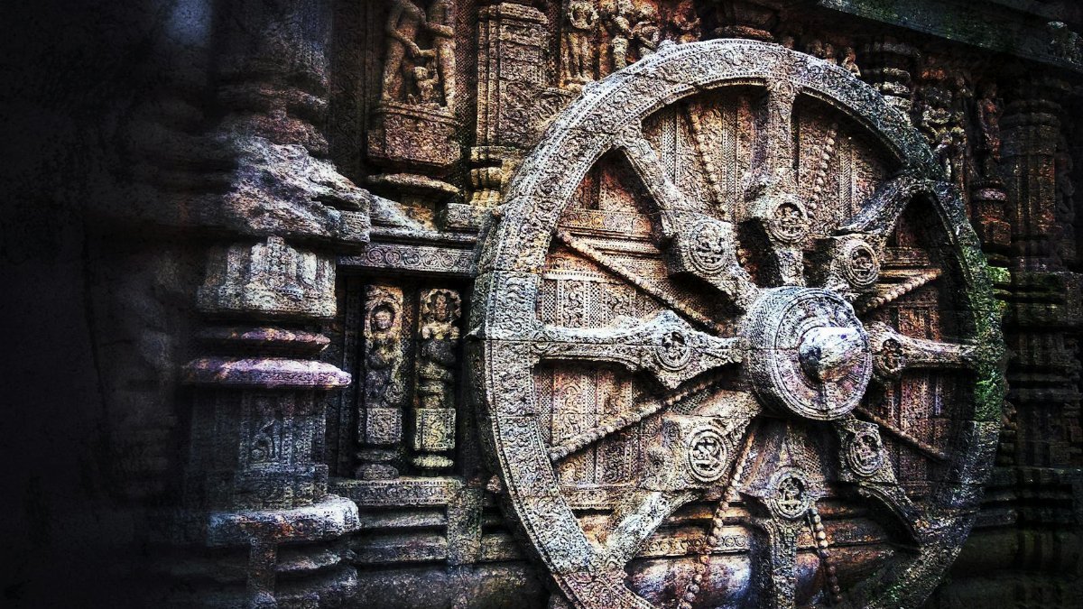 Intricate stone carving of a chariot wheel at the historic Konark Sun Temple, India.