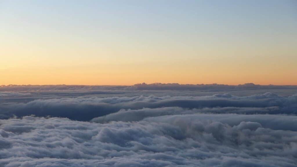 Experience the breathtaking sunrise over a sea of clouds at Haleakalā National Park, Hawaii.