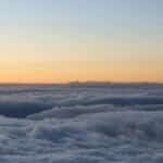 Experience the breathtaking sunrise over a sea of clouds at Haleakalā National Park, Hawaii.