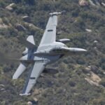 F/A-18 Super Hornet flying over rugged terrain in Kernville, California.