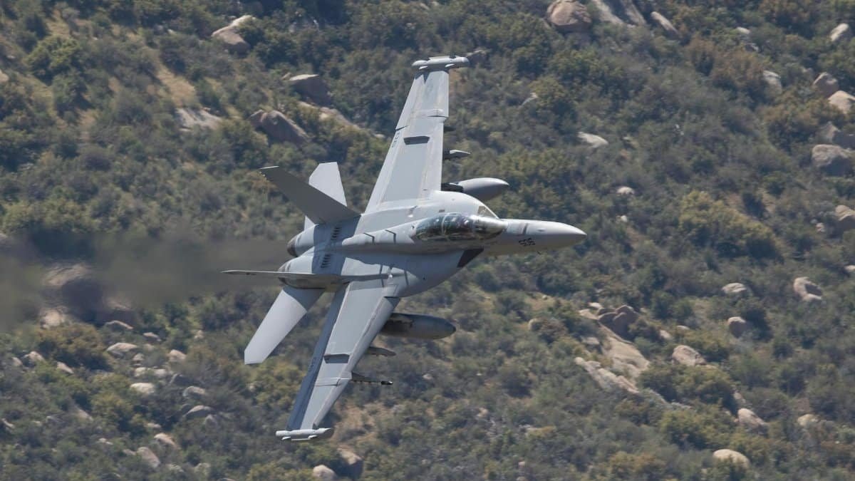 F/A-18 Super Hornet flying over rugged terrain in Kernville, California.