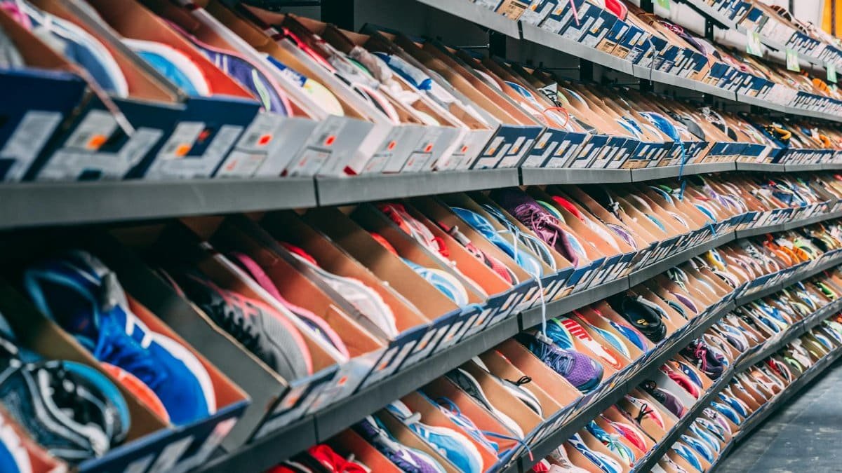 A vibrant display of various sneakers on shelves in a shoe store, showcasing styles and options.