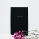 Minimalist art highlighting suicide awareness with flowers on a white background.