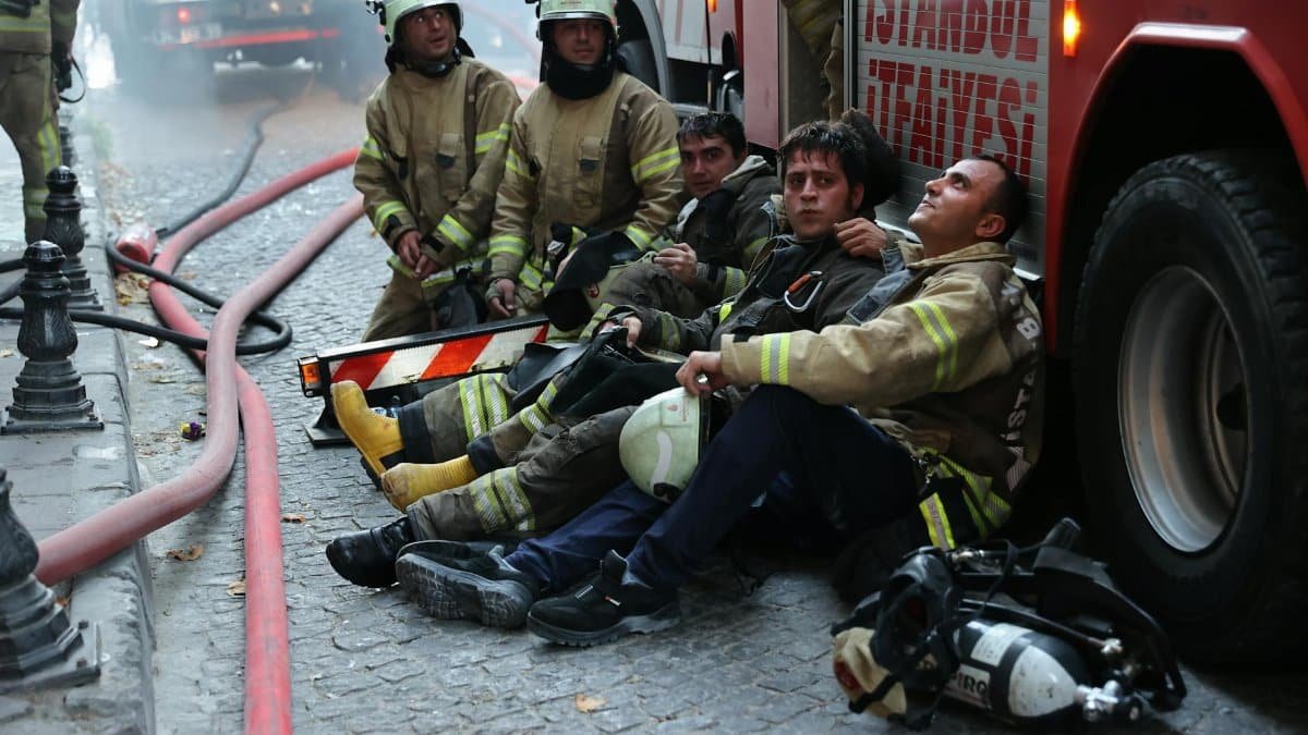 Brave firefighters taking a break post-operation in Istanbul. Captured during a firefighting incident.