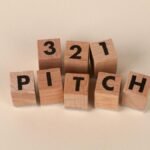 Wooden blocks arranged to spell '3-2-1 Pitch' on a beige background. Perfect for marketing themes.