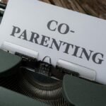 Close-up of a typewriter with a co-parenting document, symbolizing effective collaboration.