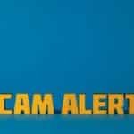 Bold yellow 'Scam Alert' text on a vivid blue surface, emphasizing warning and caution.