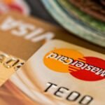 Macro shot of credit cards showing Visa and Mastercard logos next to a wallet, ideal for finance themes.