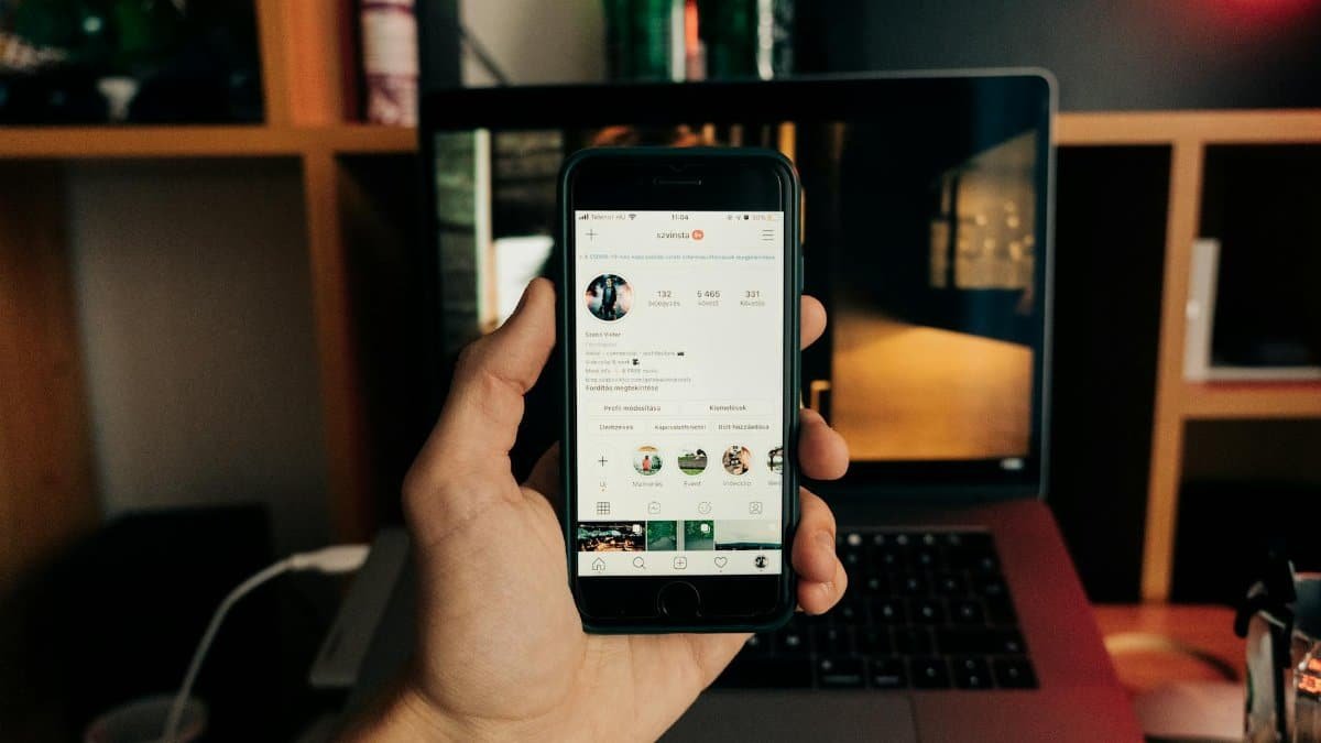 Close-up of a hand holding a smartphone with Instagram open, showcasing technology in use.