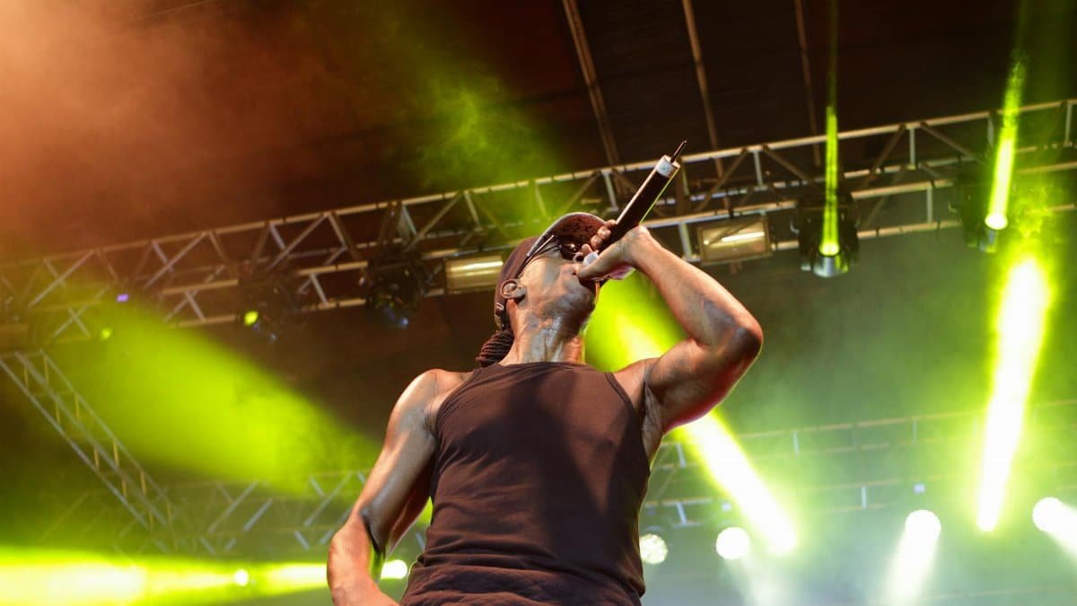 Energetic performance by male artist on stage with vibrant lighting in Brazil.