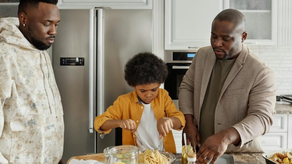 Father and son prepare dinner in a stylish kitchen, enjoying quality time together.