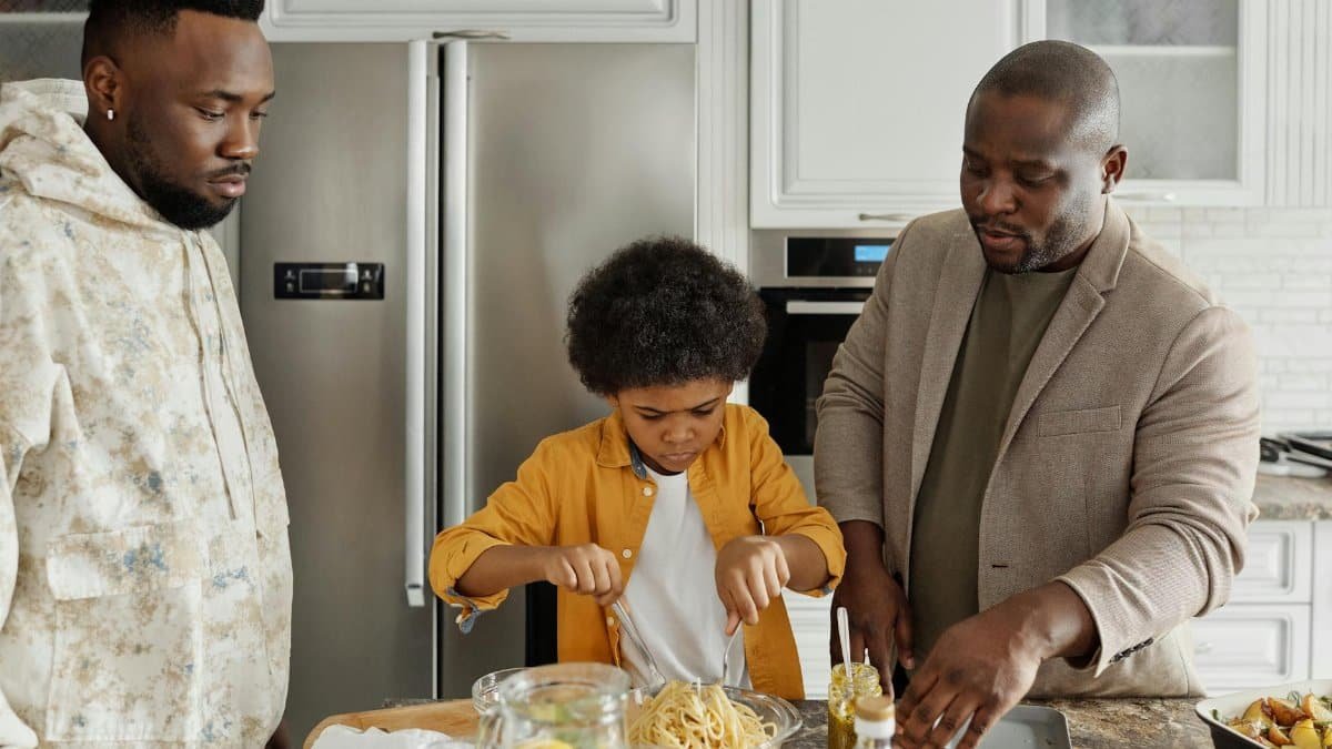 Father and son prepare dinner in a stylish kitchen, enjoying quality time together.