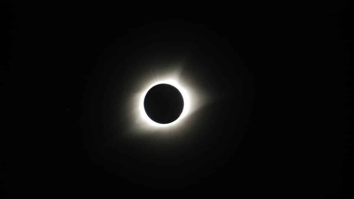 Captivating image of a total solar eclipse showcasing the sun's corona in the dark sky.