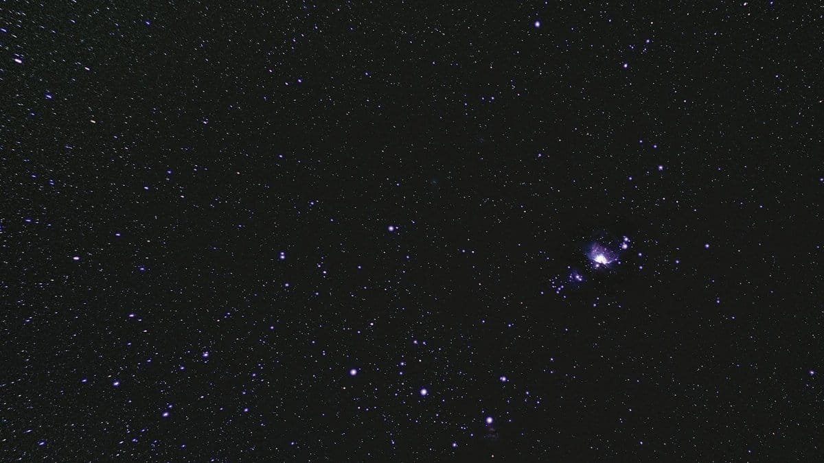Stunning astrophotography of a starry night sky highlighting the Orion Nebula.