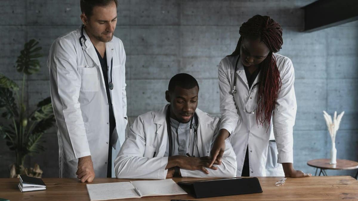 Doctors in discussion at a medical clinic, working on patient treatment plans.