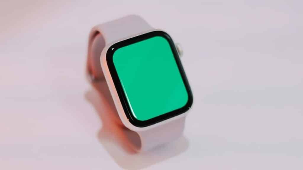 Smartwatch with a blank green screen displayed on a light background, suitable for mockups.