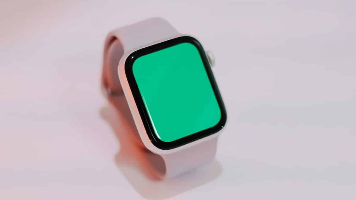 Smartwatch with a blank green screen displayed on a light background, suitable for mockups.
