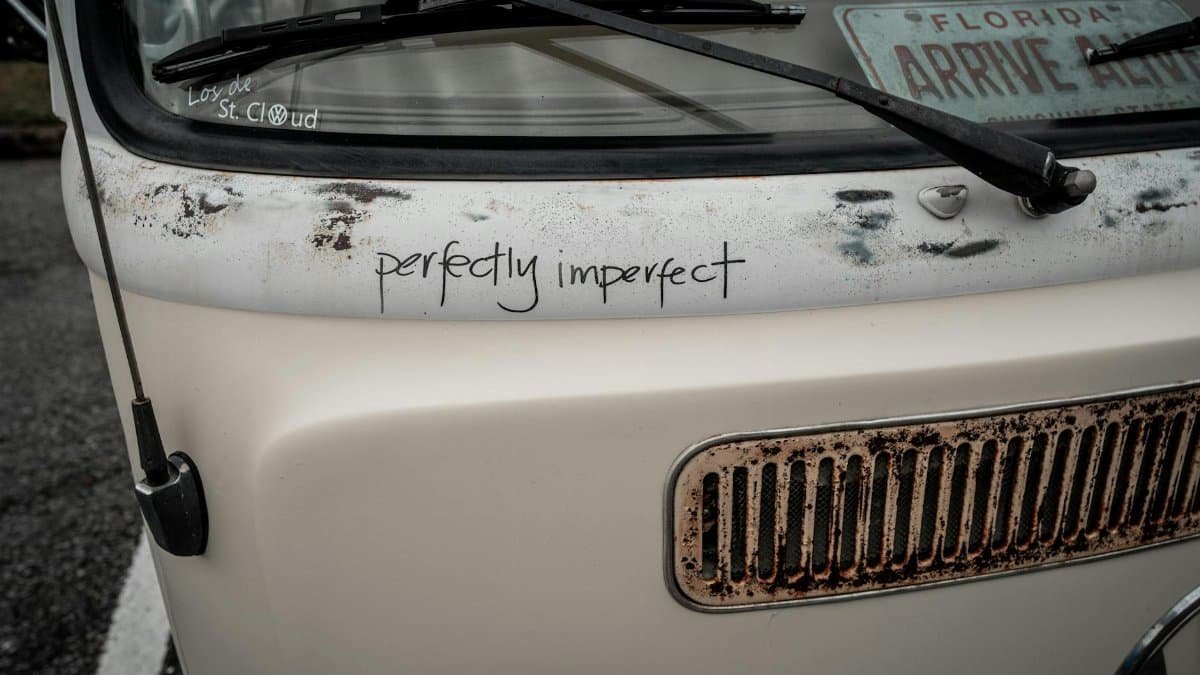 Close-up of a classic VW microbus showcasing its 'perfectly imperfect' charm and rust details in Florida.