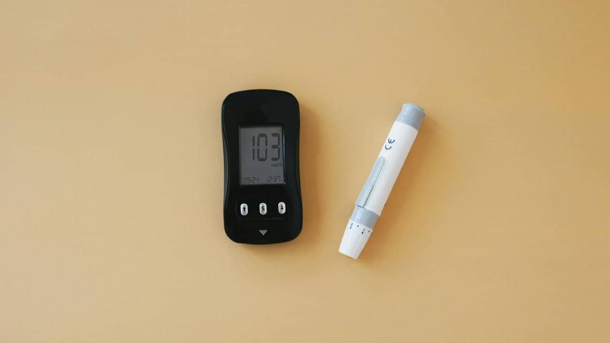 Close-up of a glucose meter and lancet pen, essential for diabetes management.