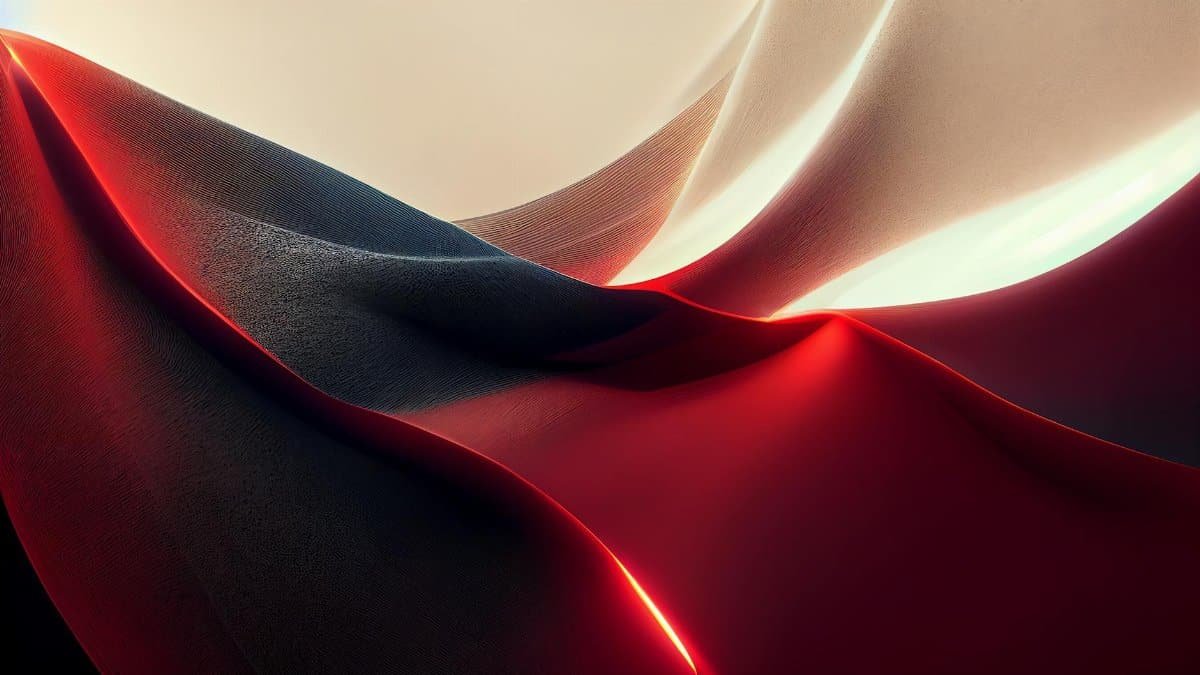 An artistic view of abstract fabric waves in red and black, conveying movement and fluidity.