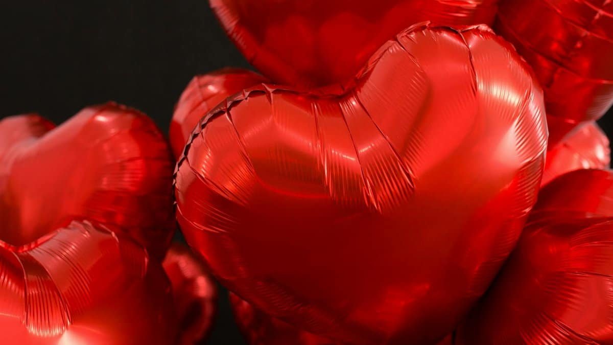 Close-up of shiny red heart-shaped balloons, perfect for Valentine's Day and romantic celebrations.