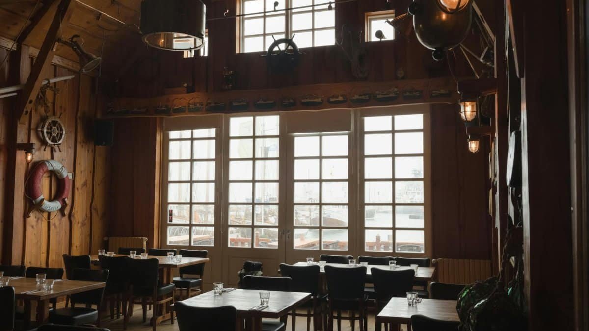 Warm and rustic interior of a nautical-themed restaurant with wooden decor and marine elements.