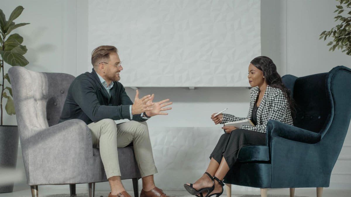 A candid interaction between a man and woman during a professional interview in a modern office setting.
