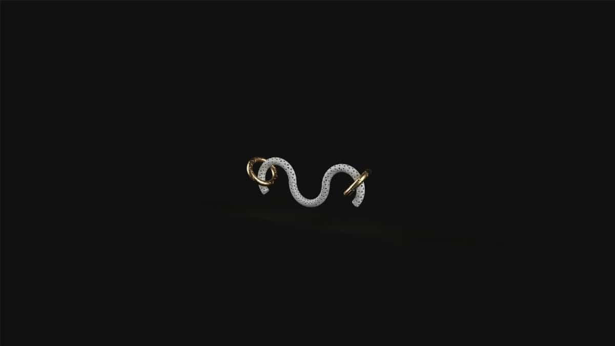 Intricate snake-shaped jewelry piece with gold accents on a black background, perfect for luxury themes.