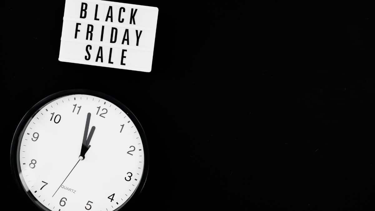 Black Friday sale sign with a clock showing urgency on a black background.