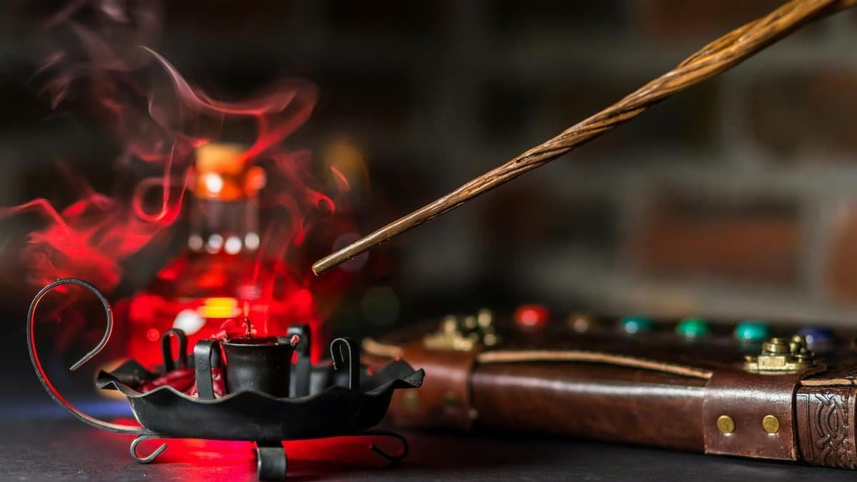A mystical scene featuring a magic wand, smoke, and colorful gemstone encrusted book.