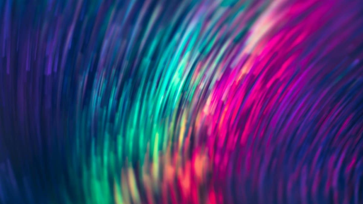 A dynamic abstract light pattern with vibrant swirling colors creating a captivating visual effect.