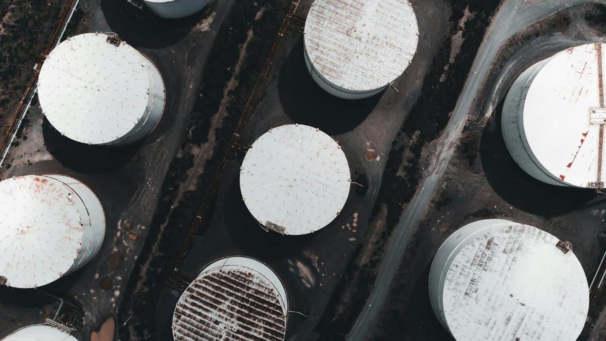 Drone shot showcasing large industrial storage tanks from above.